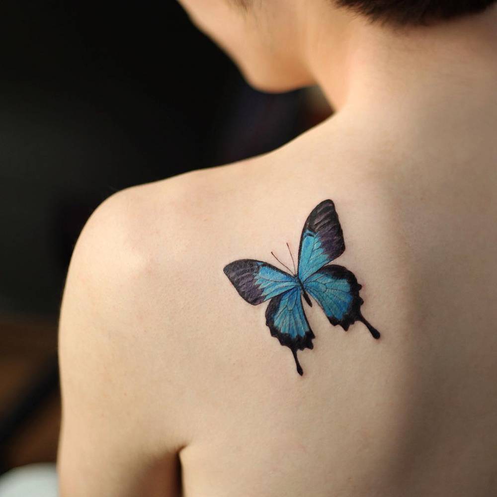 Blue butterfly tattoo on back