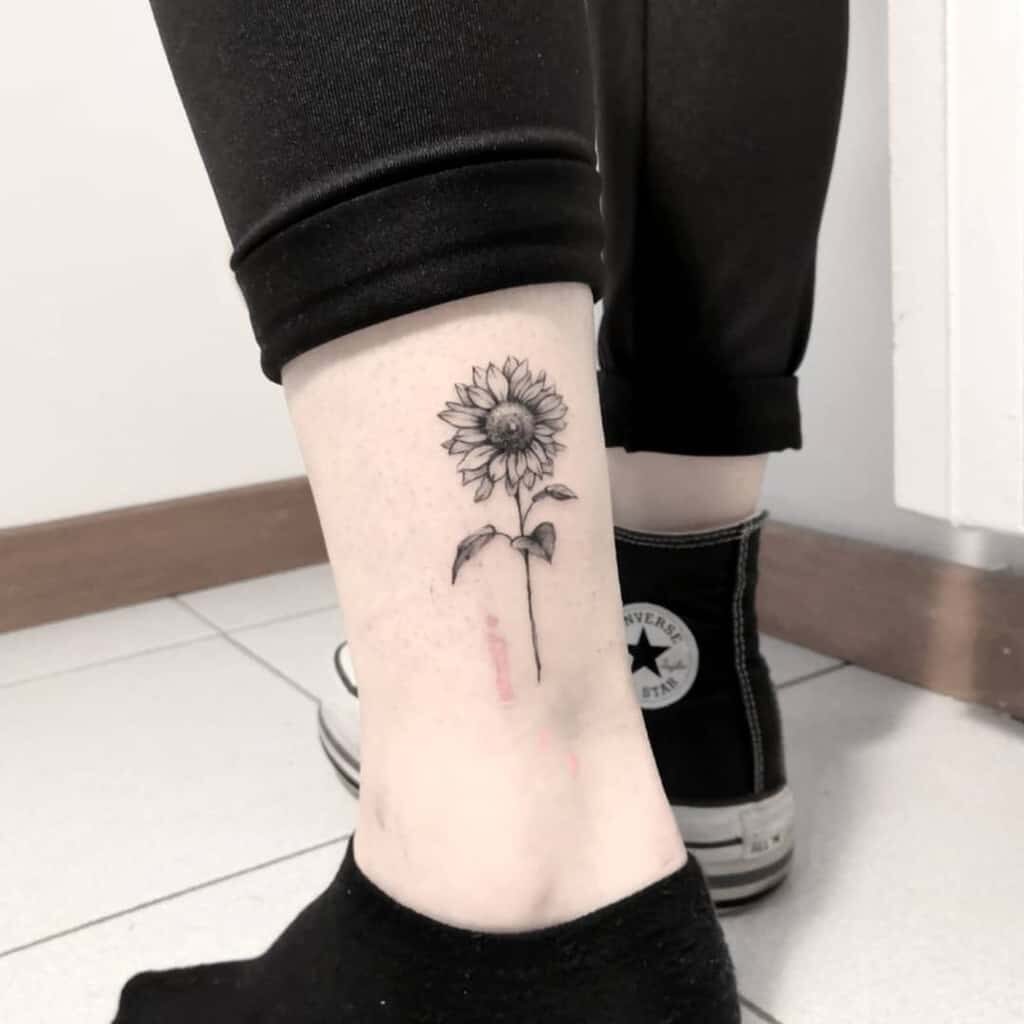 black Sunflower Tattoo on girls leg